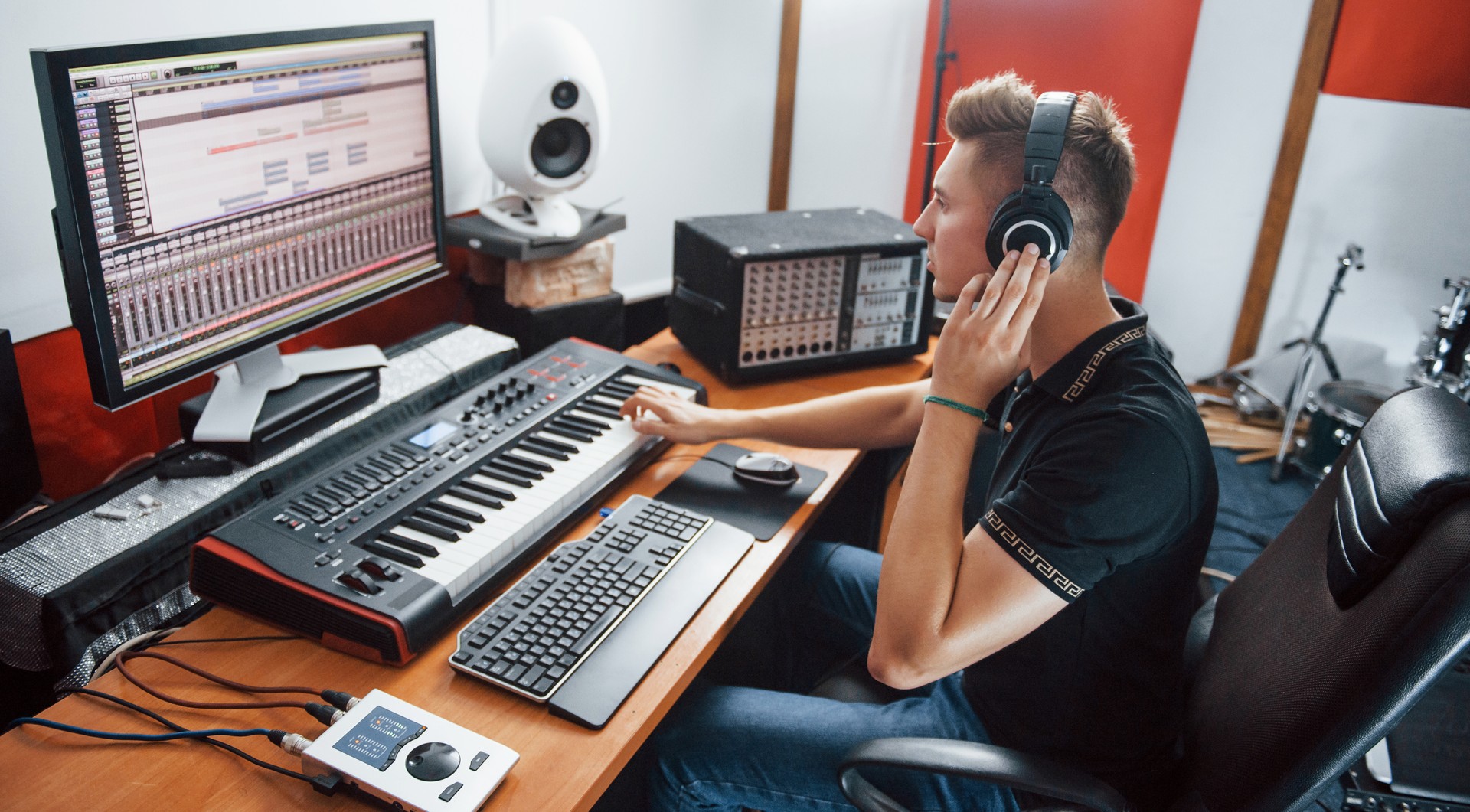 Sound engineer in headphones working and mixing music indoors in the studio